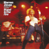 the album cover for Warren Zevon - Stand In The Fire: Recorded Live At The Roxy [LP]